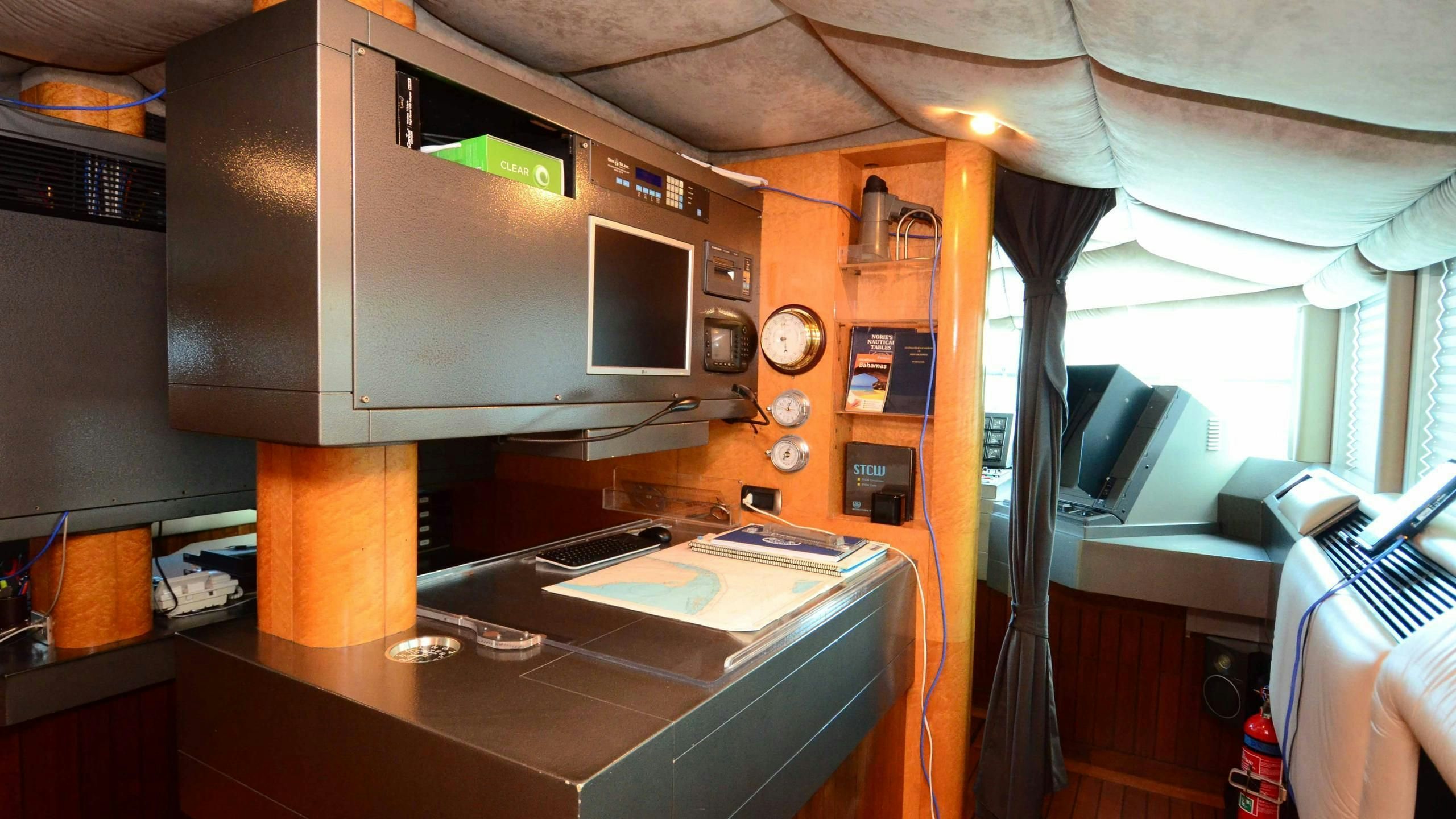 a room with a desk and computer aboard KORU Yacht for Charter