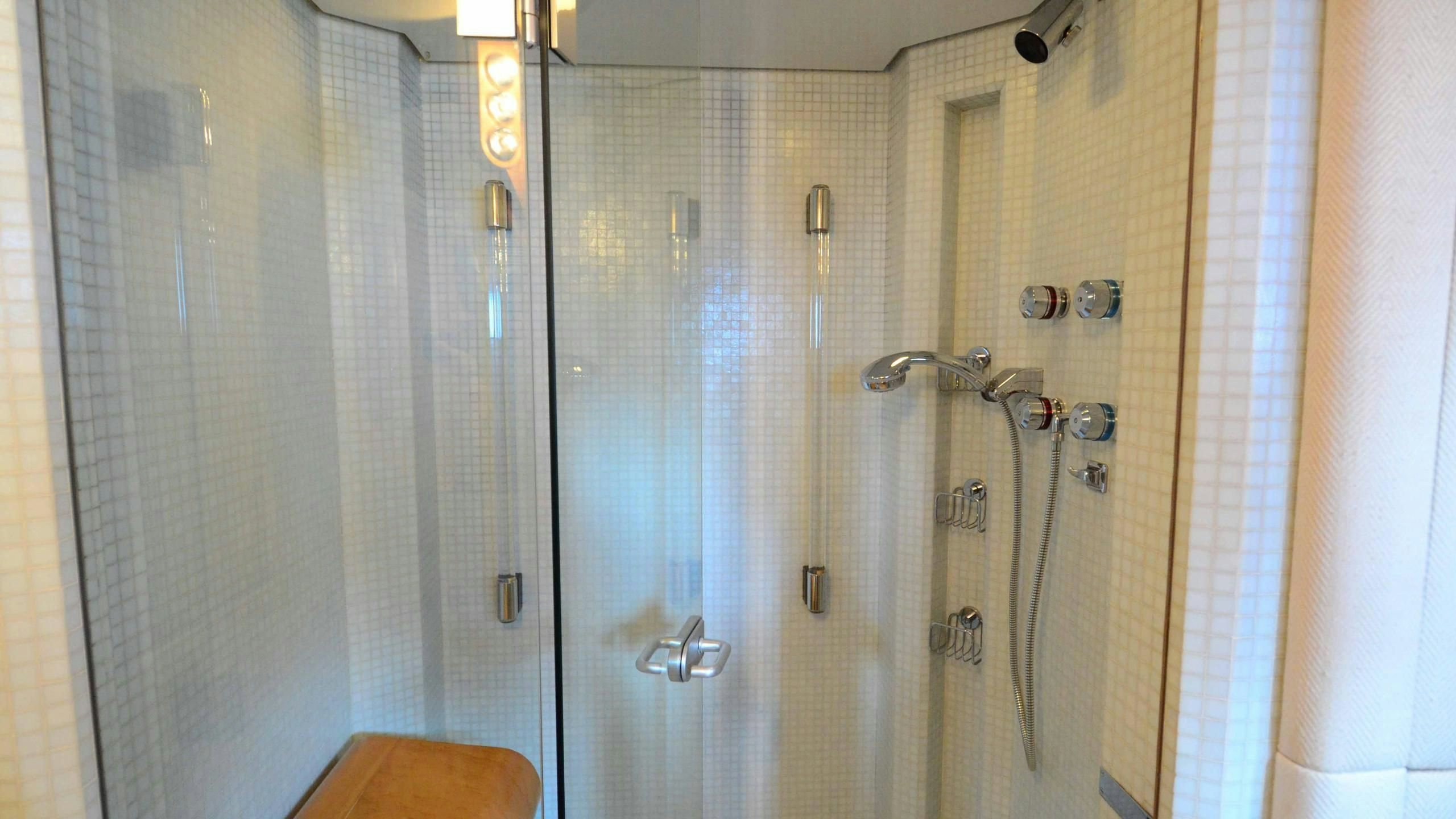 a shower with a glass door aboard KORU Yacht for Charter