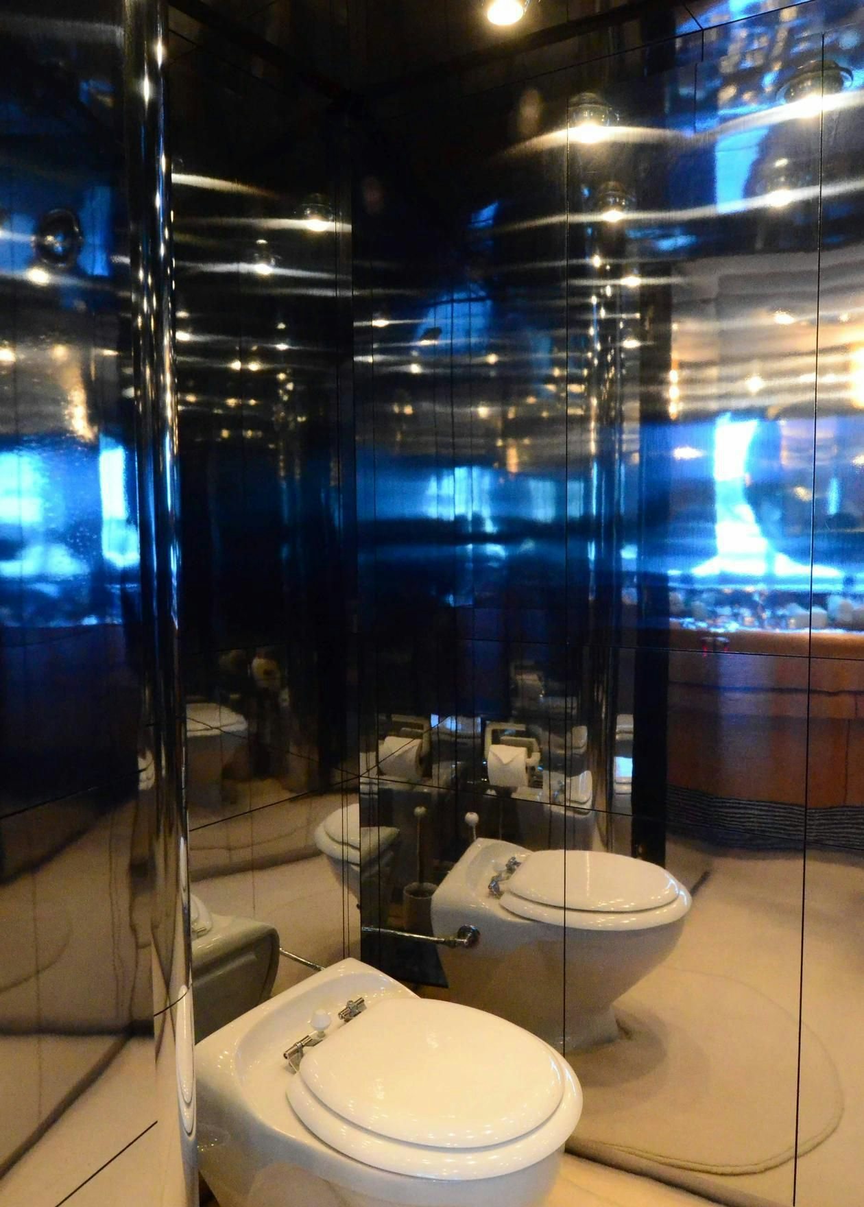 a bathroom with a glass wall aboard KORU Yacht for Charter