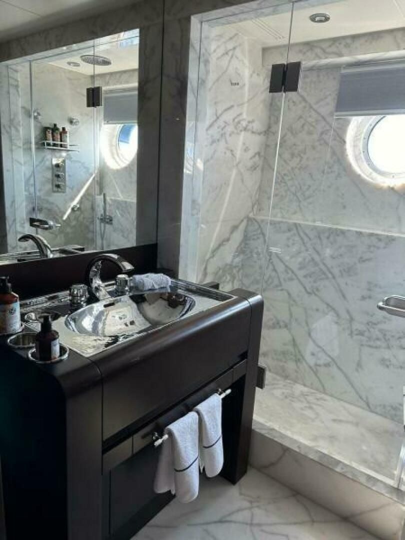 a bathroom with a sink and mirror aboard KORU Yacht for Charter