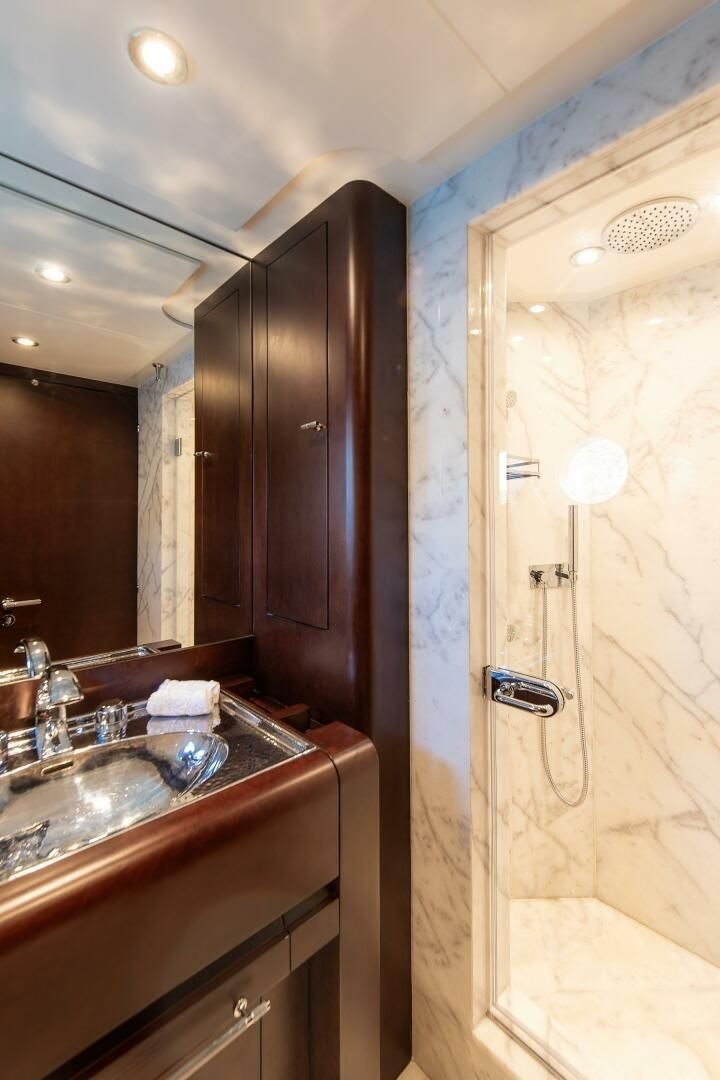 a bathroom with a sink and a shower aboard KORU Yacht for Charter