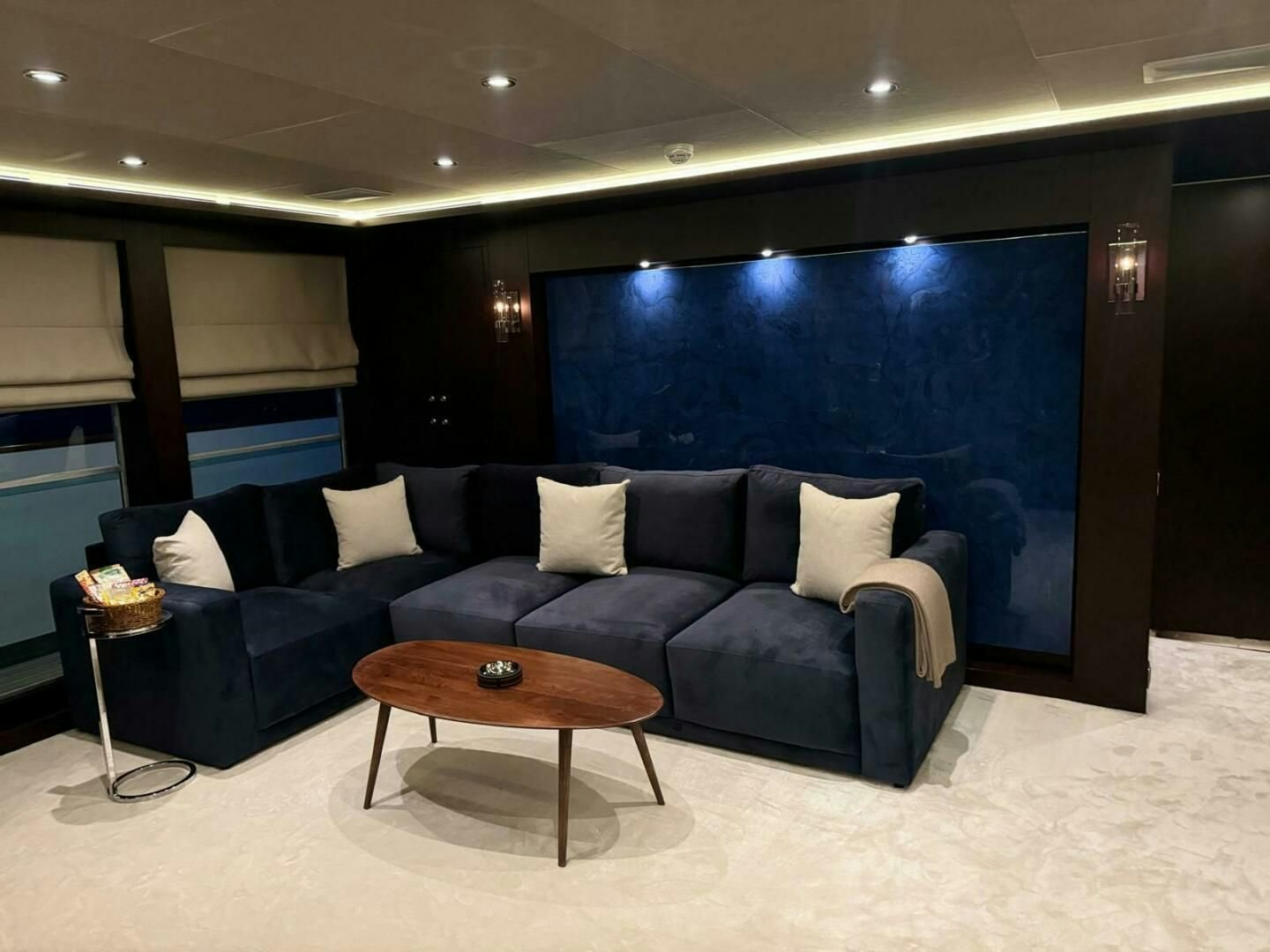 a couch and a table in a room aboard KORU Yacht for Charter
