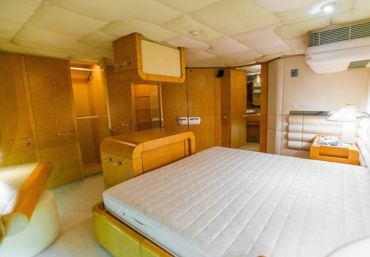 a room with a bed and a desk aboard KORU Yacht for Charter