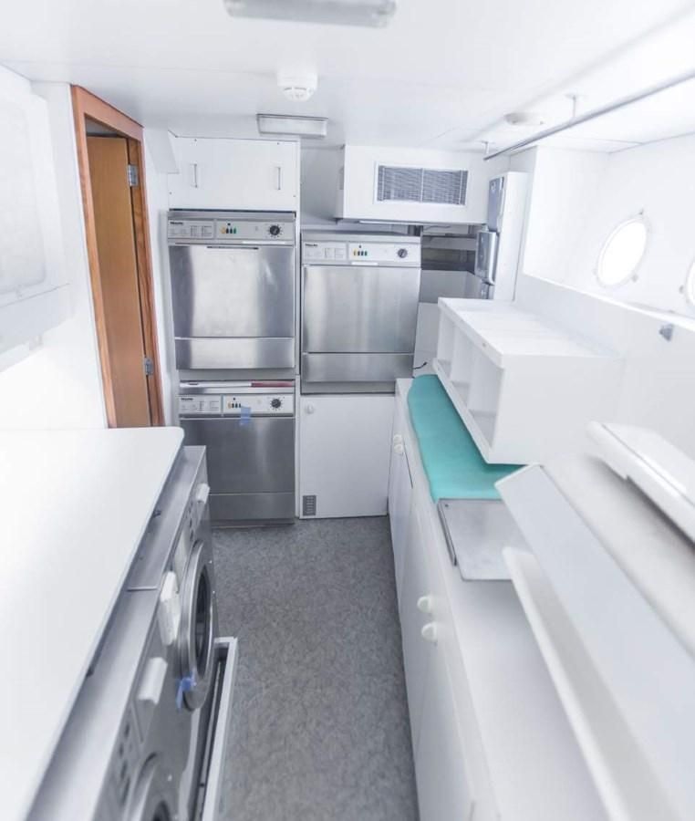 a kitchen with stainless steel appliances aboard KORU Yacht for Charter