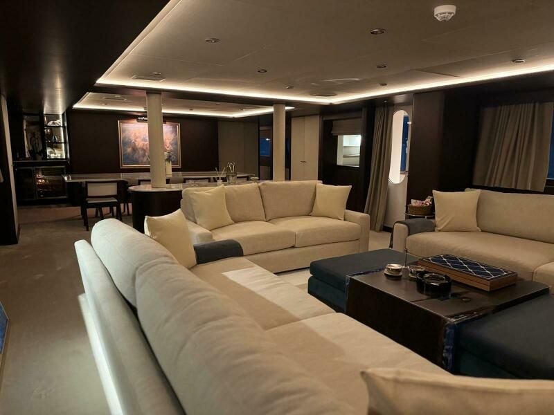 a living room with a couch and a coffee table aboard KORU Yacht for Charter