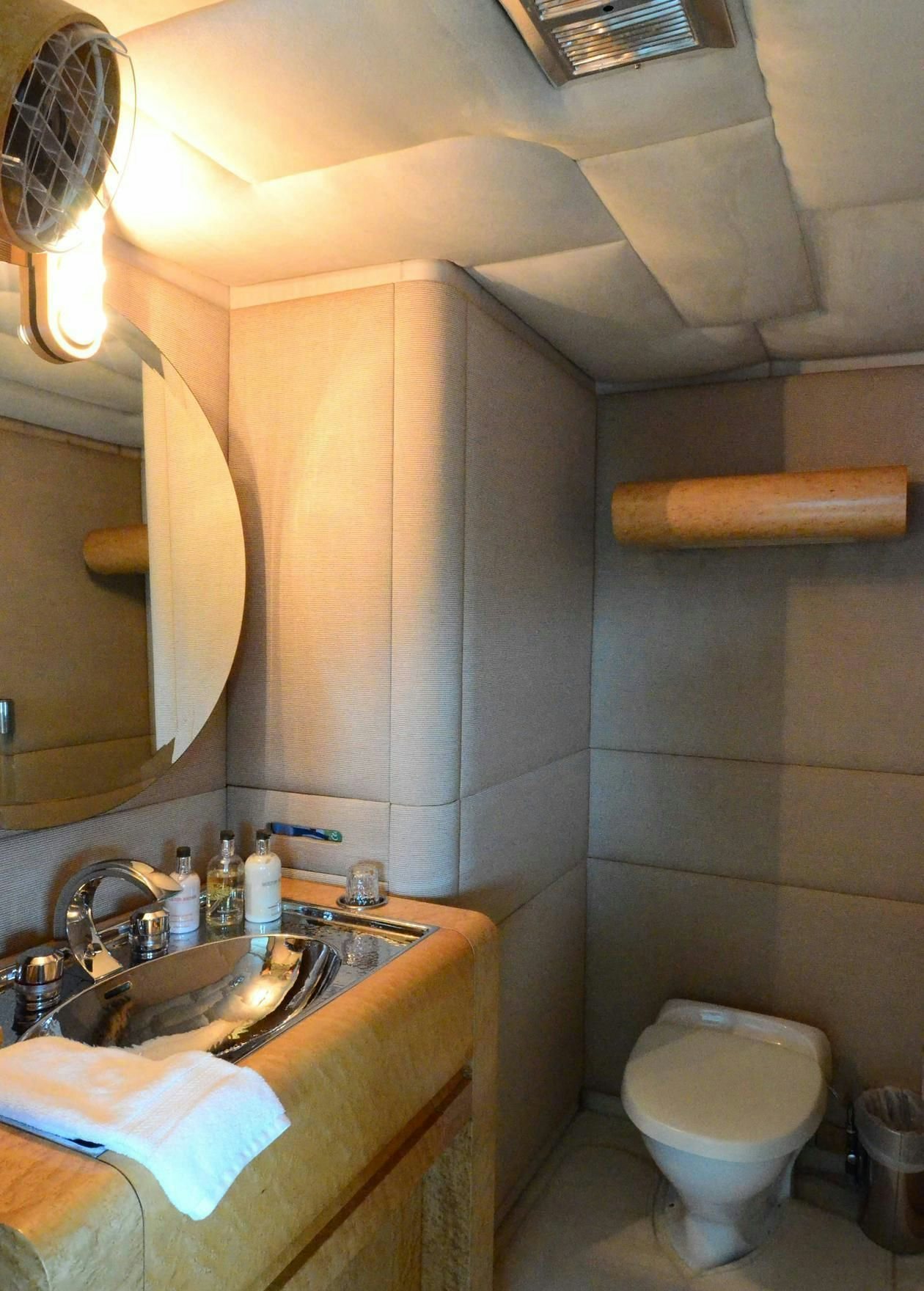 a bathroom with a toilet sink and a mirror aboard KORU Yacht for Charter