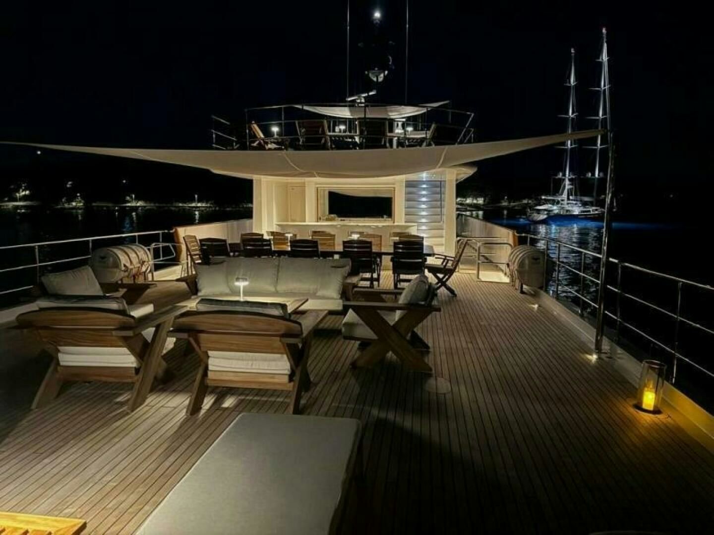 a room with a large pool table and chairs aboard KORU Yacht for Charter