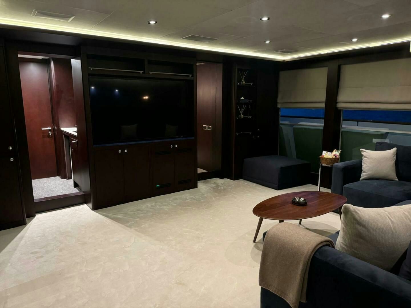 a room with a couch and a television aboard KORU Yacht for Charter