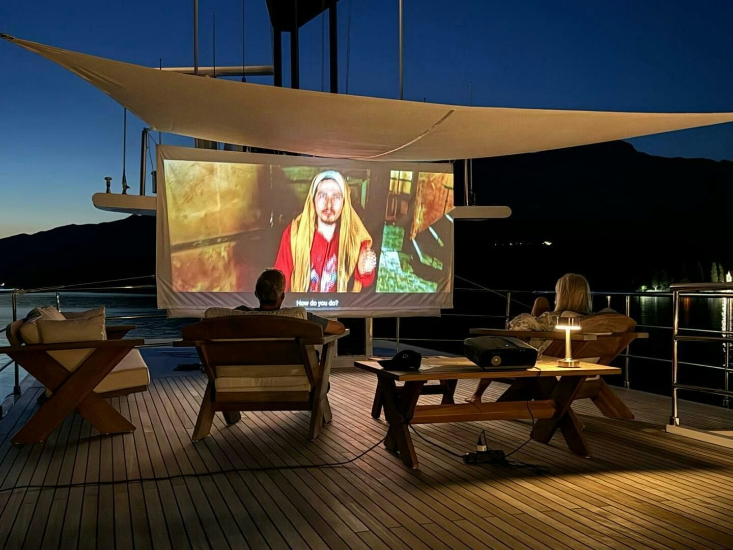 a large screen with a picture of a person on it aboard KORU Yacht for Charter
