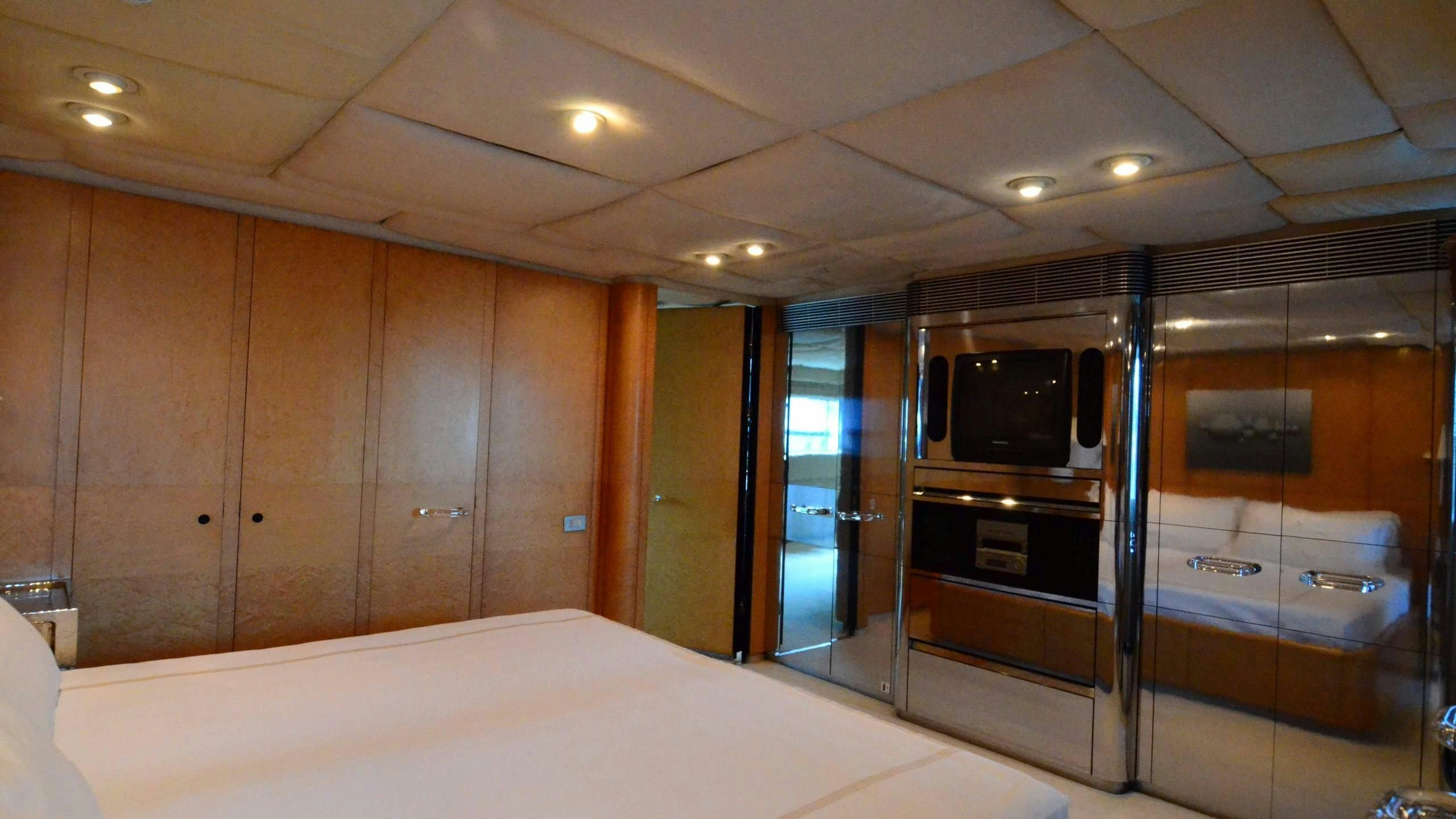 a room with a large mirror and a tv in it aboard KORU Yacht for Charter
