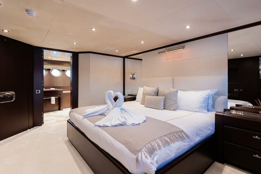 a large bed in a hotel room aboard KORU Yacht for Charter