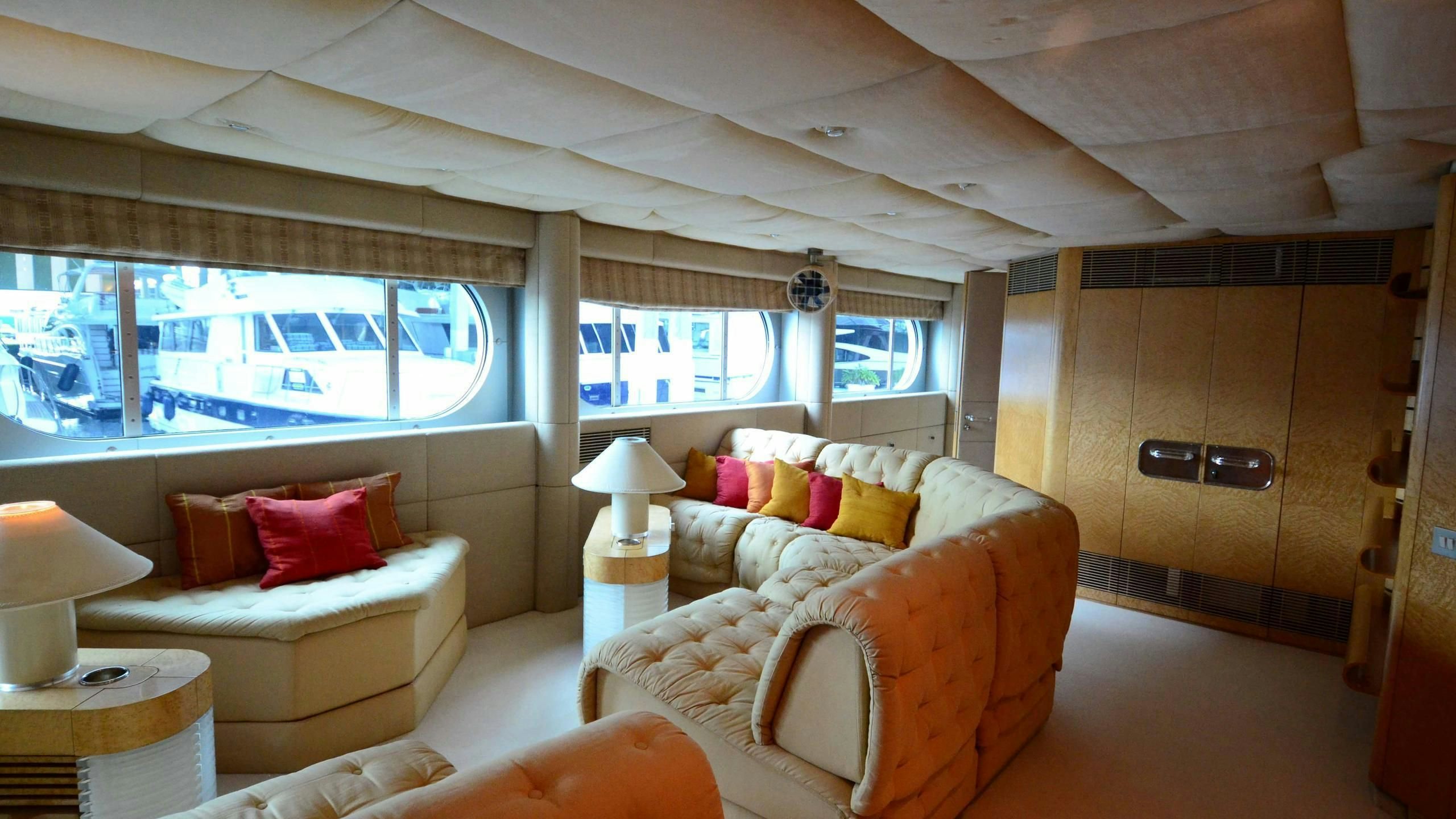 a room with a couch and a window aboard KORU Yacht for Charter