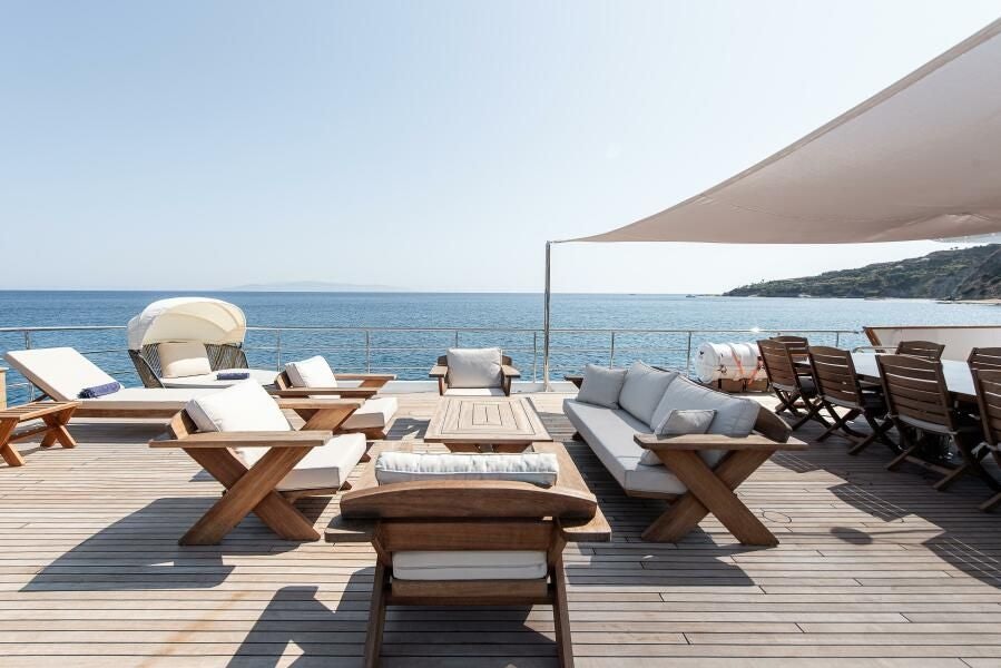 a patio with chairs and tables aboard KORU Yacht for Charter