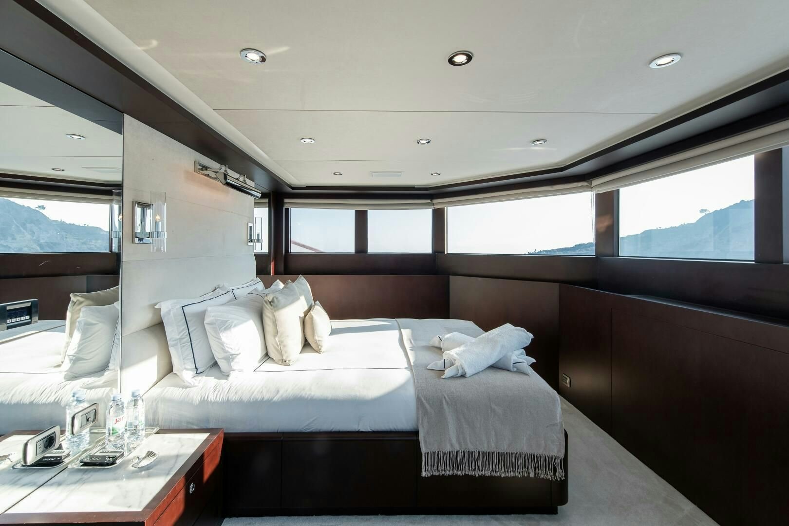 a room with a bed and a table aboard KORU Yacht for Charter
