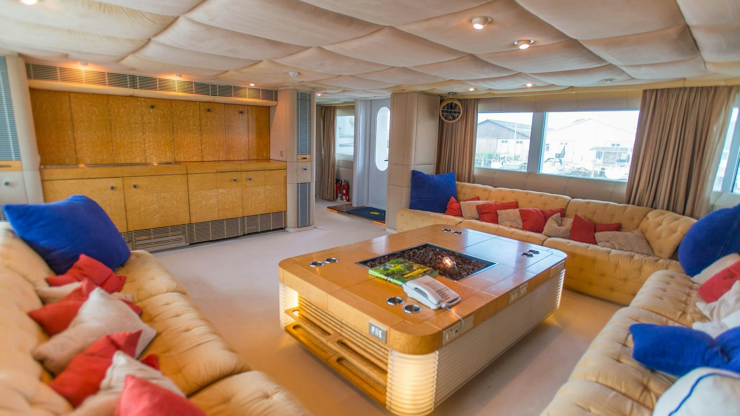 a living room with a couch and a table aboard KORU Yacht for Charter