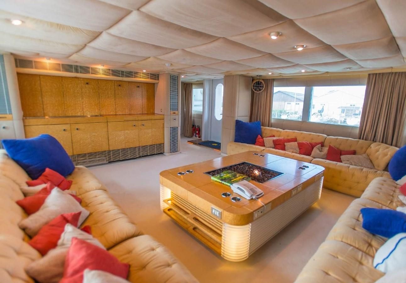a living room with a couch and a table aboard KORU Yacht for Charter