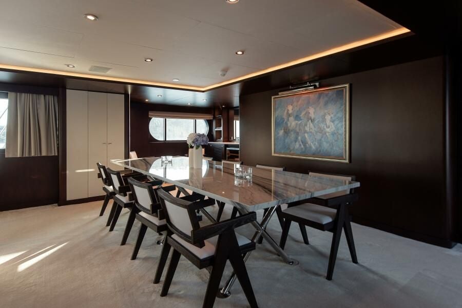 a room with a table and chairs aboard KORU Yacht for Charter