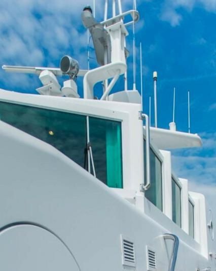a white boat with a satellite dish aboard KORU Yacht for Charter