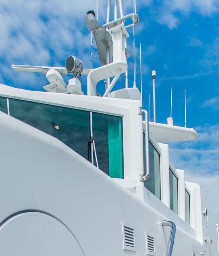 a white boat with a green door aboard KORU Yacht for Charter