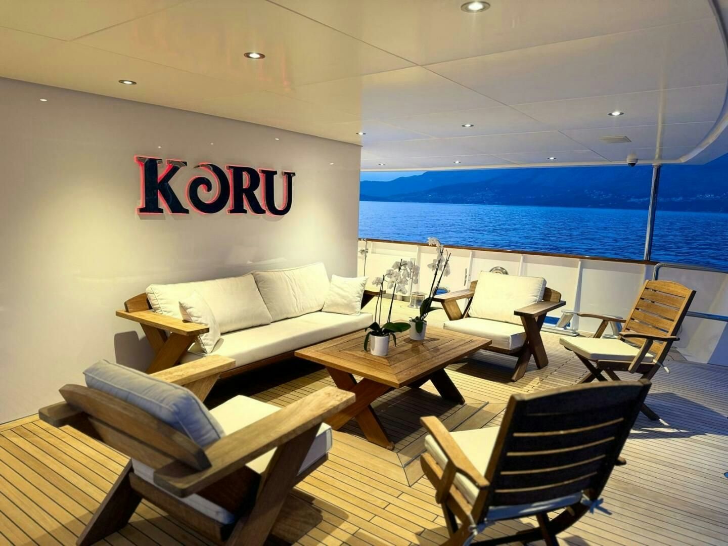 a room with a couch and chairs aboard KORU Yacht for Charter