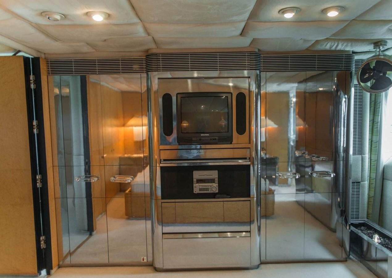 a room with a tv and a closet aboard KORU Yacht for Charter