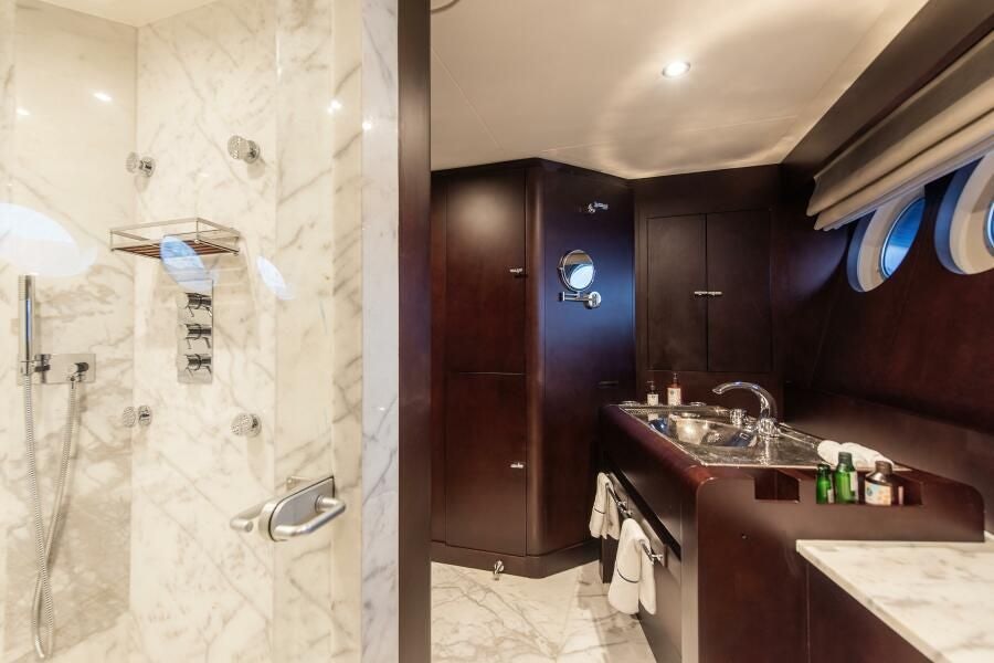 a bathroom with a sink and a mirror aboard KORU Yacht for Charter