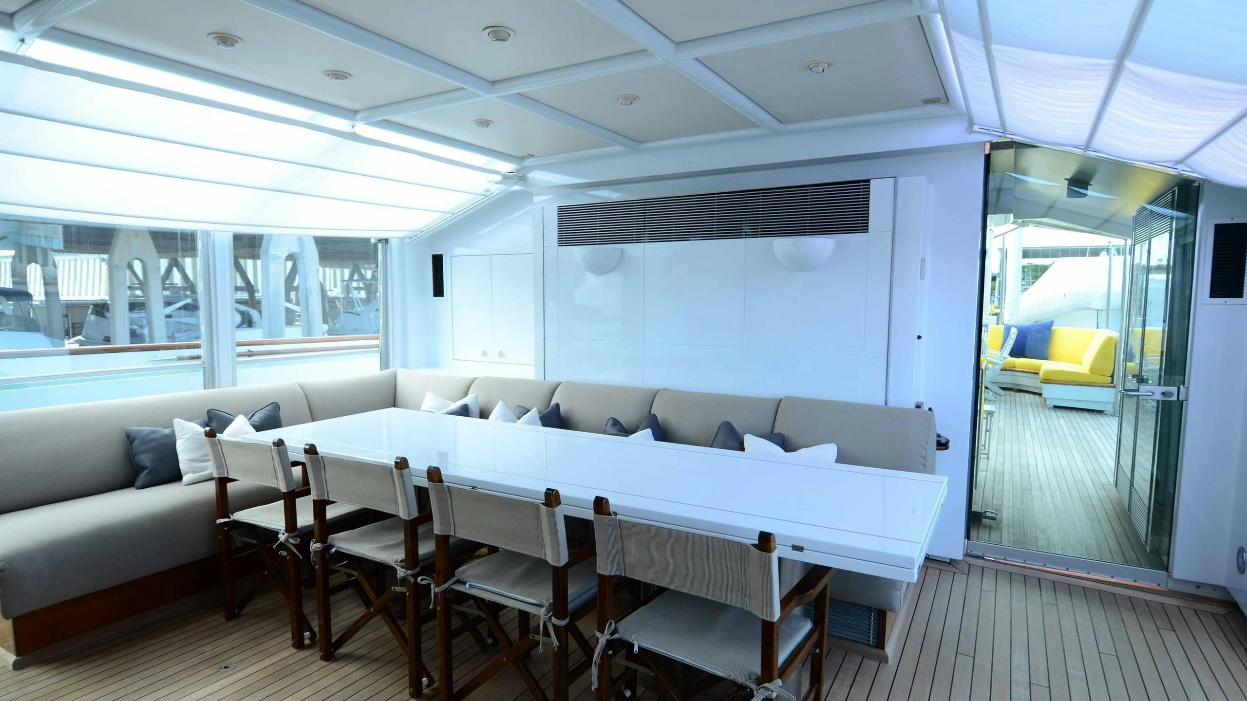 a room with a couch and a table and chairs aboard KORU Yacht for Charter