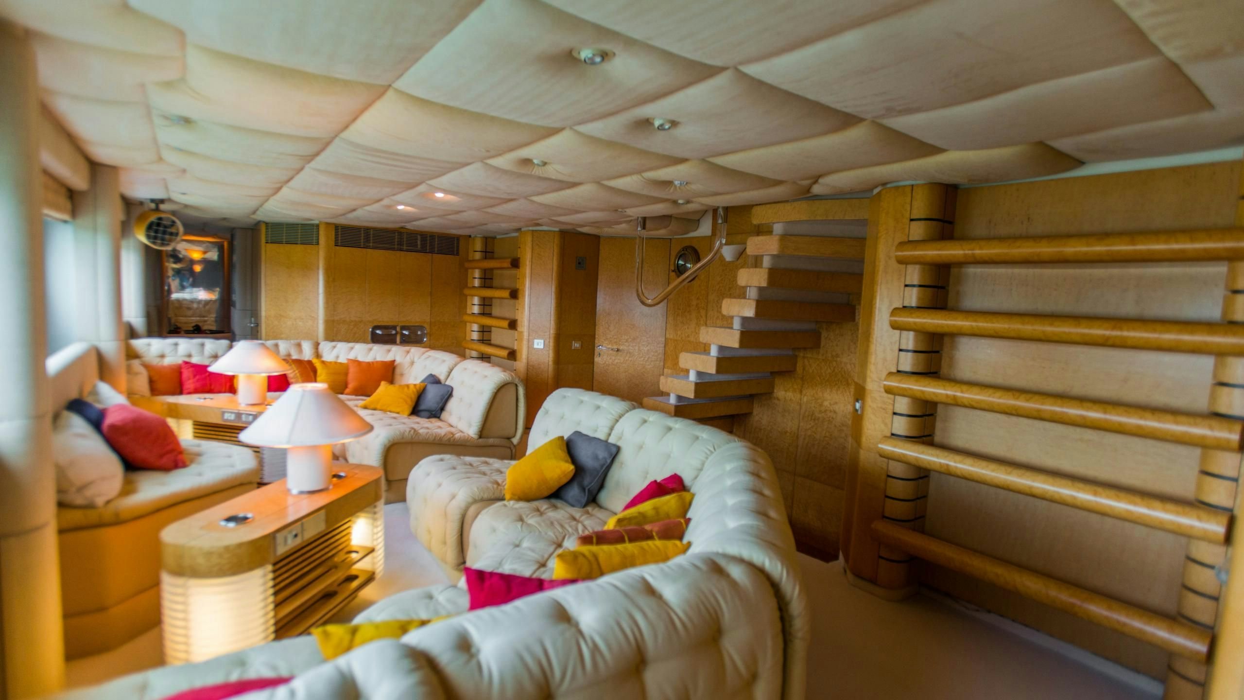 a room with a bed and a staircase aboard KORU Yacht for Charter