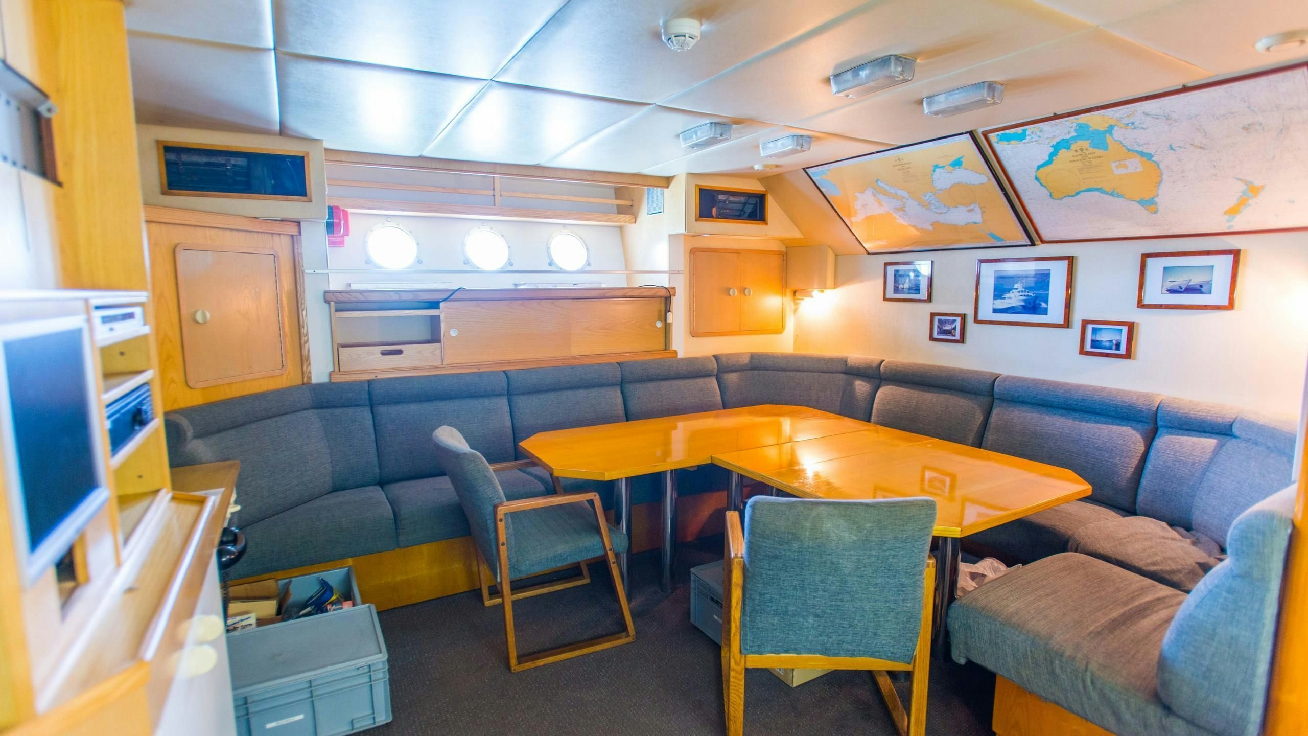 a room with a couch and a table aboard KORU Yacht for Charter