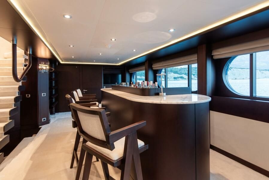 a room with a table and chairs aboard KORU Yacht for Charter