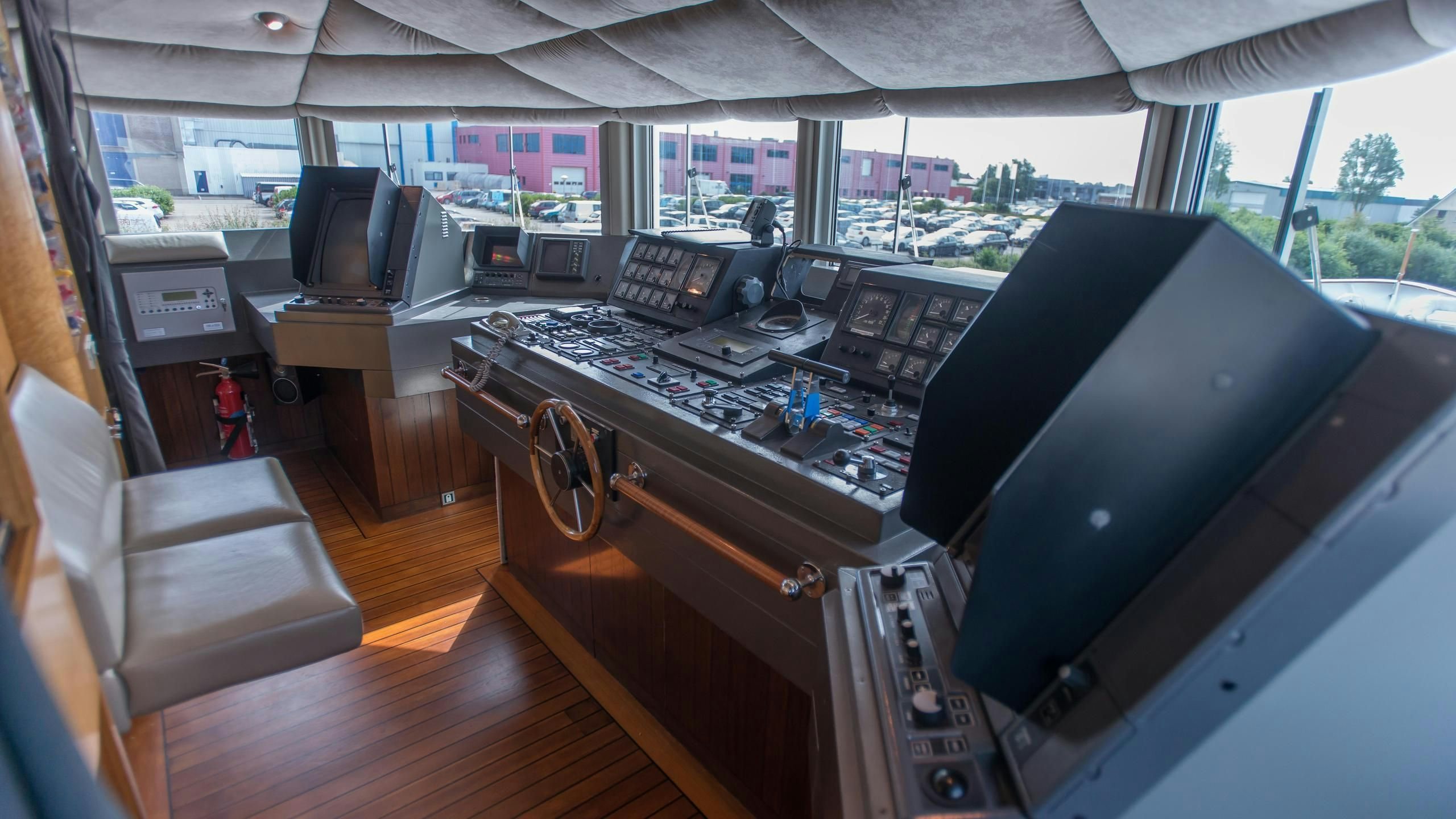 a room with a desk and chairs aboard KORU Yacht for Charter