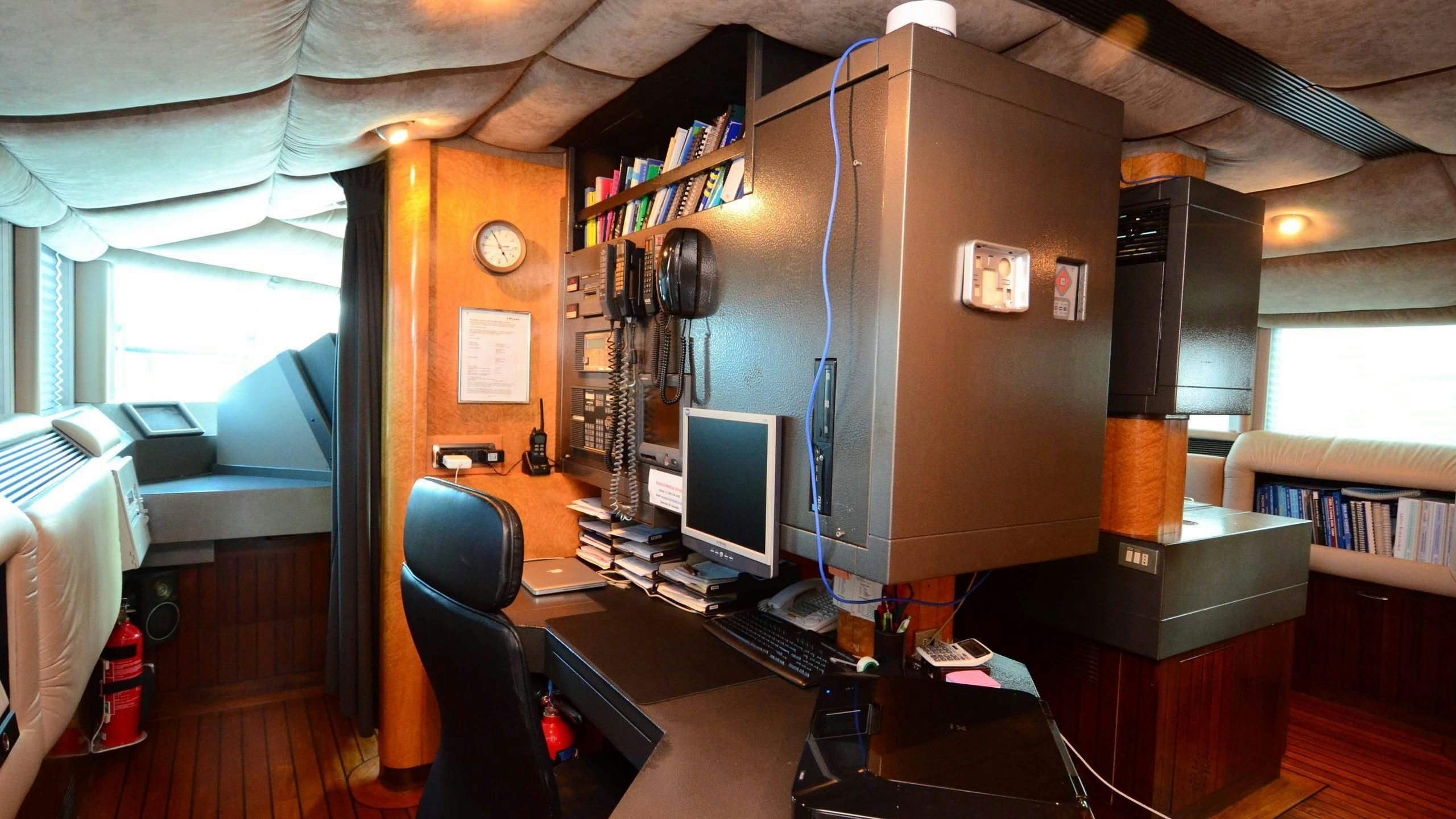 a room with a desk and computer aboard KORU Yacht for Charter
