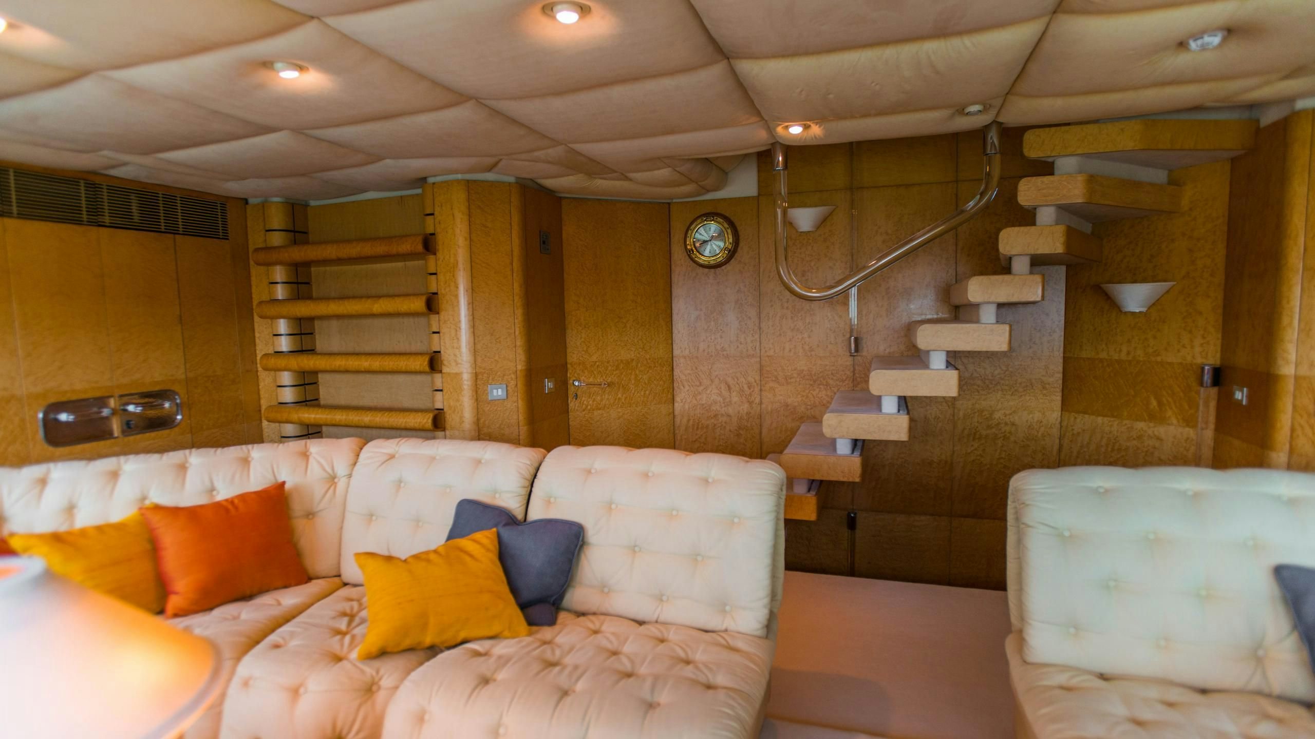 a room with a couch and a staircase aboard KORU Yacht for Charter