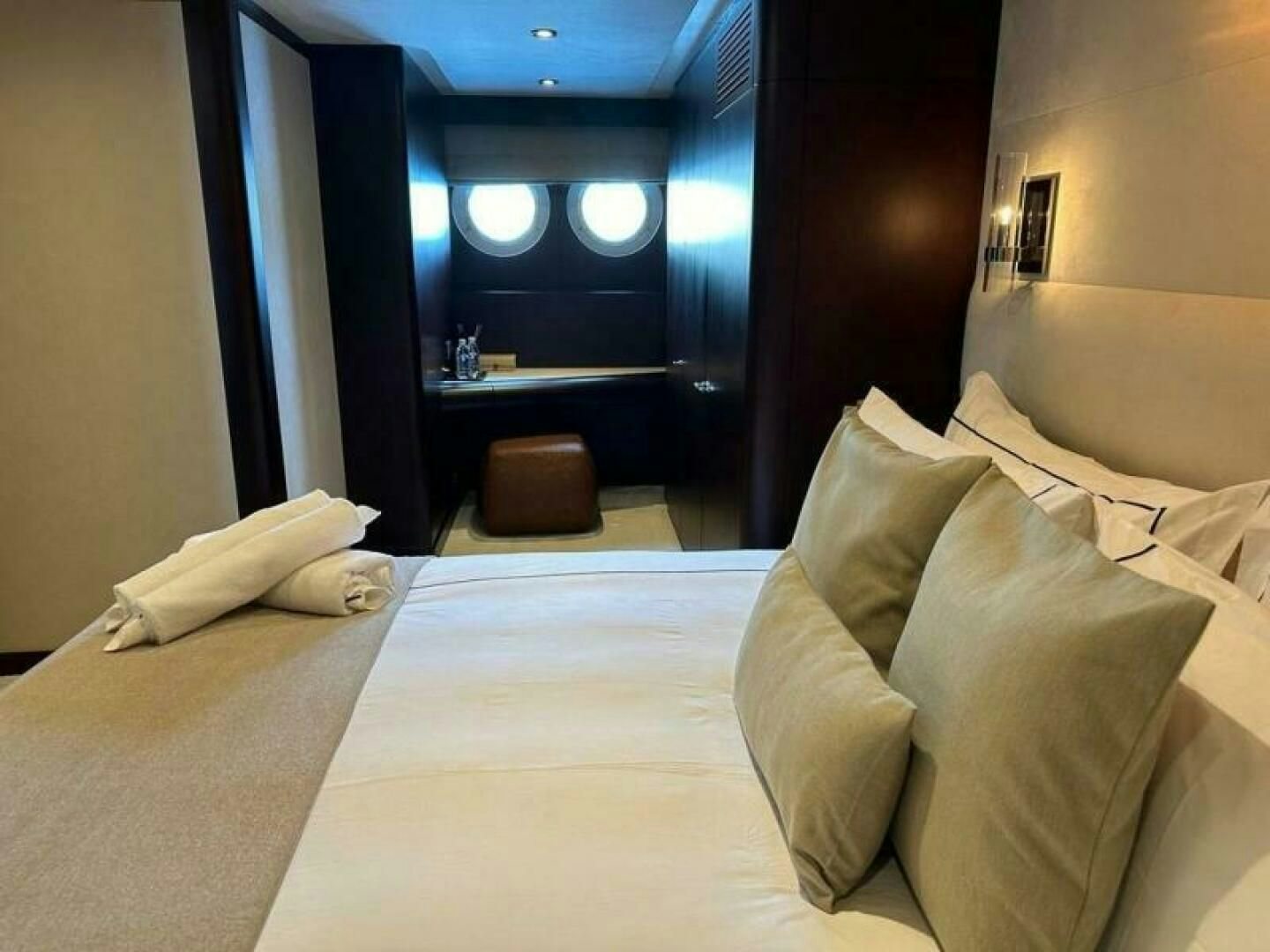 a bed with white sheets aboard KORU Yacht for Charter