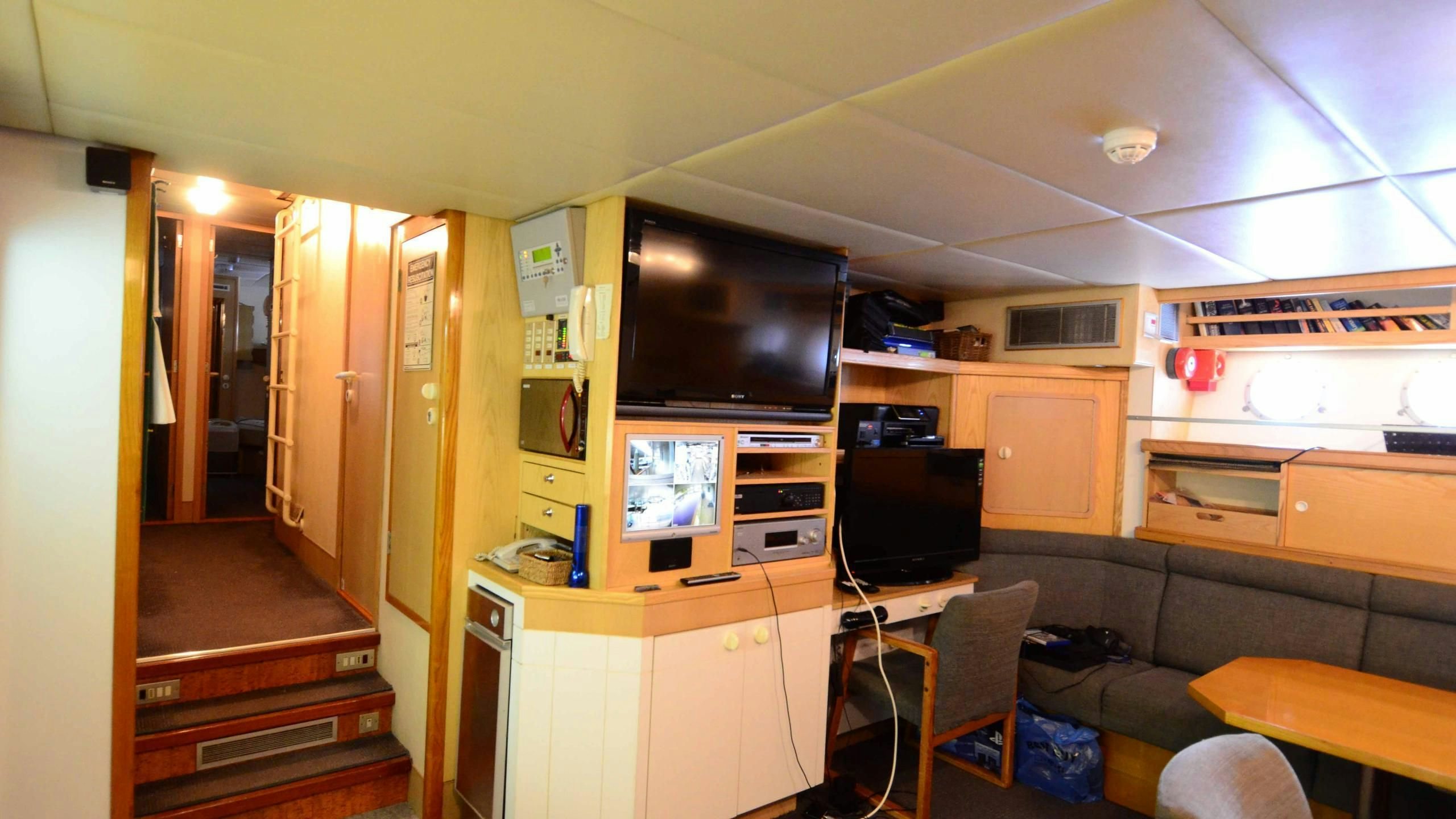 a living room with a tv and a couch aboard KORU Yacht for Charter