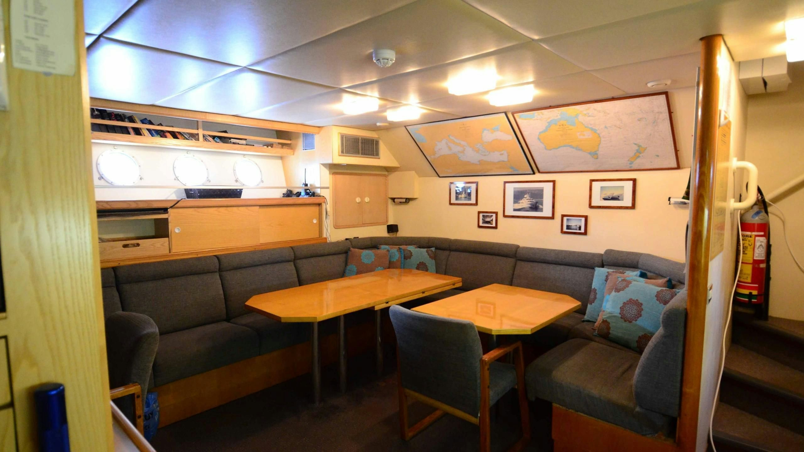 a room with a couch and a table and chairs aboard KORU Yacht for Charter