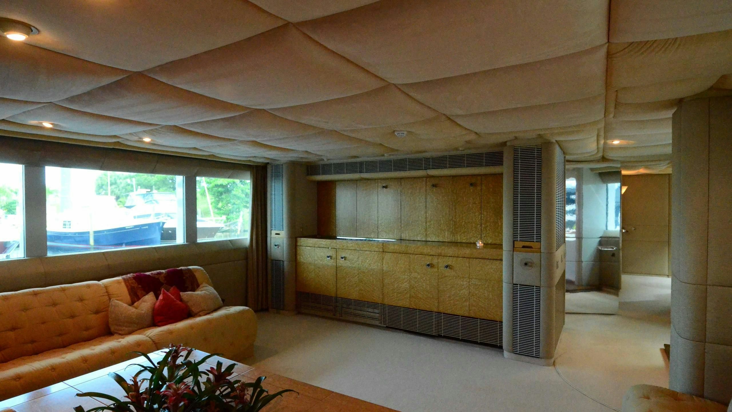 a living room with a large glass door aboard KORU Yacht for Charter