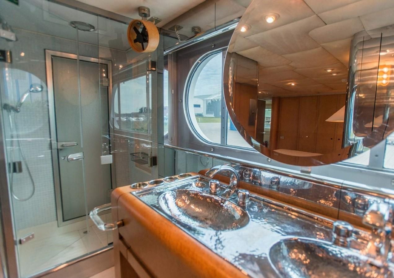 a bathroom with a sink and a mirror aboard KORU Yacht for Charter
