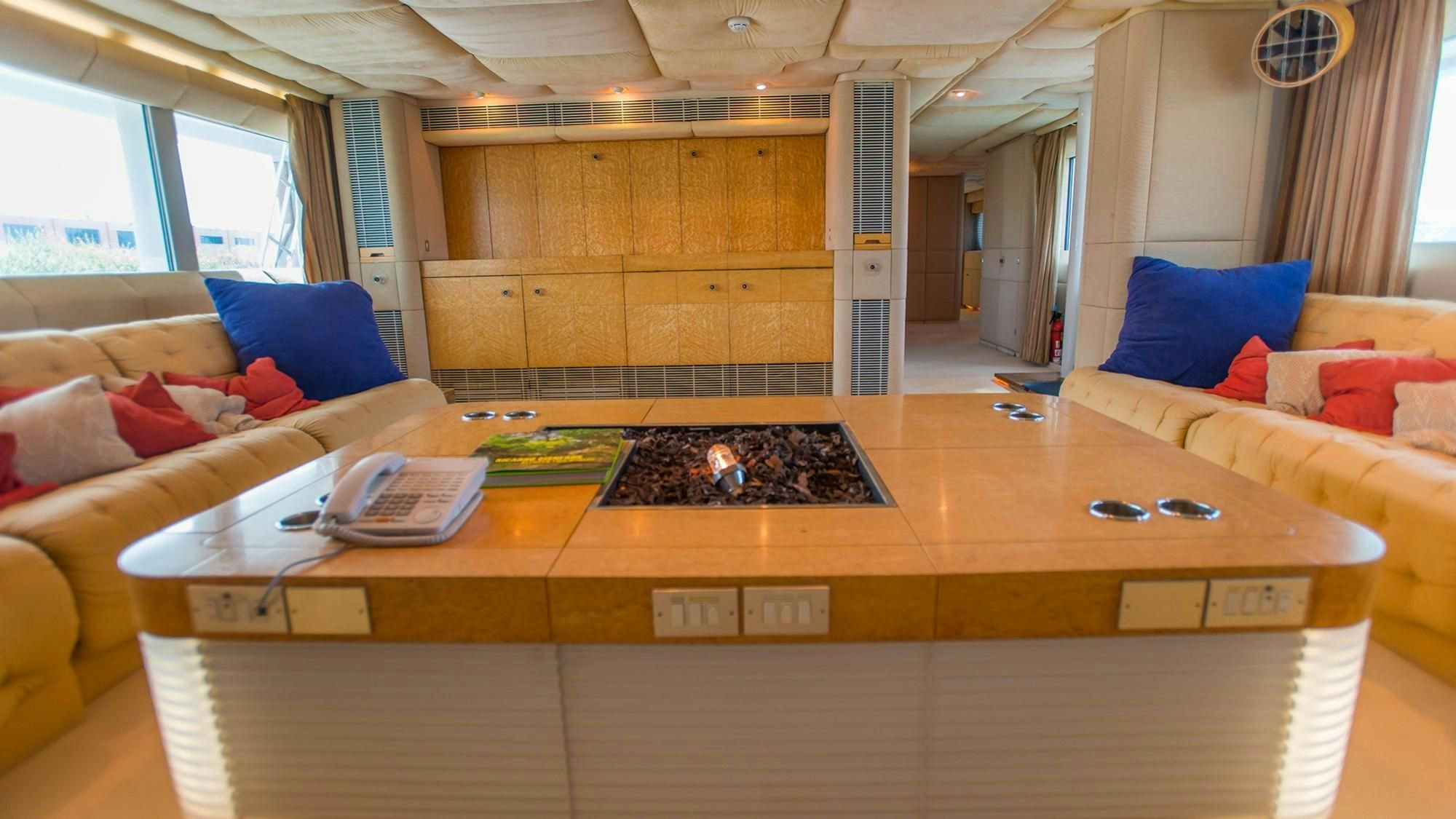a room with a couch and a table aboard KORU Yacht for Charter