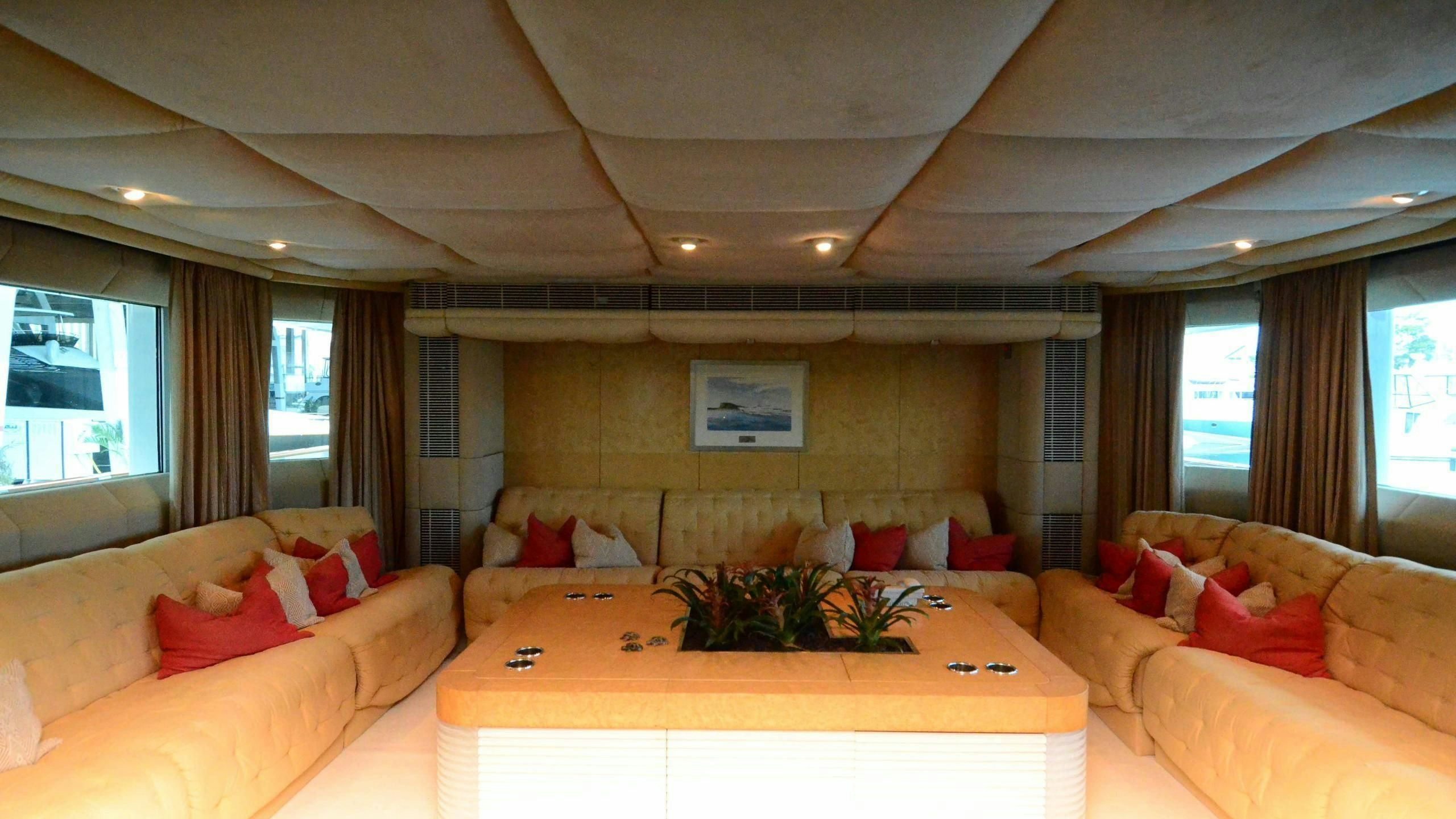 a living room with a table and couches aboard KORU Yacht for Charter