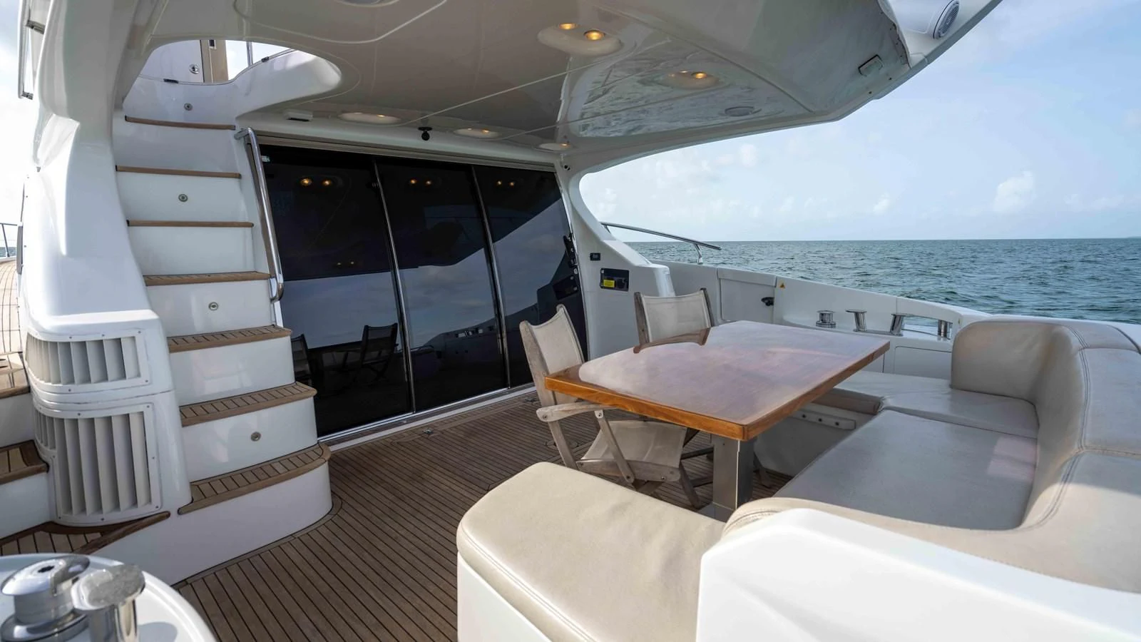 a boat with a table and chairs aboard 4-PLAY Yacht for Sale