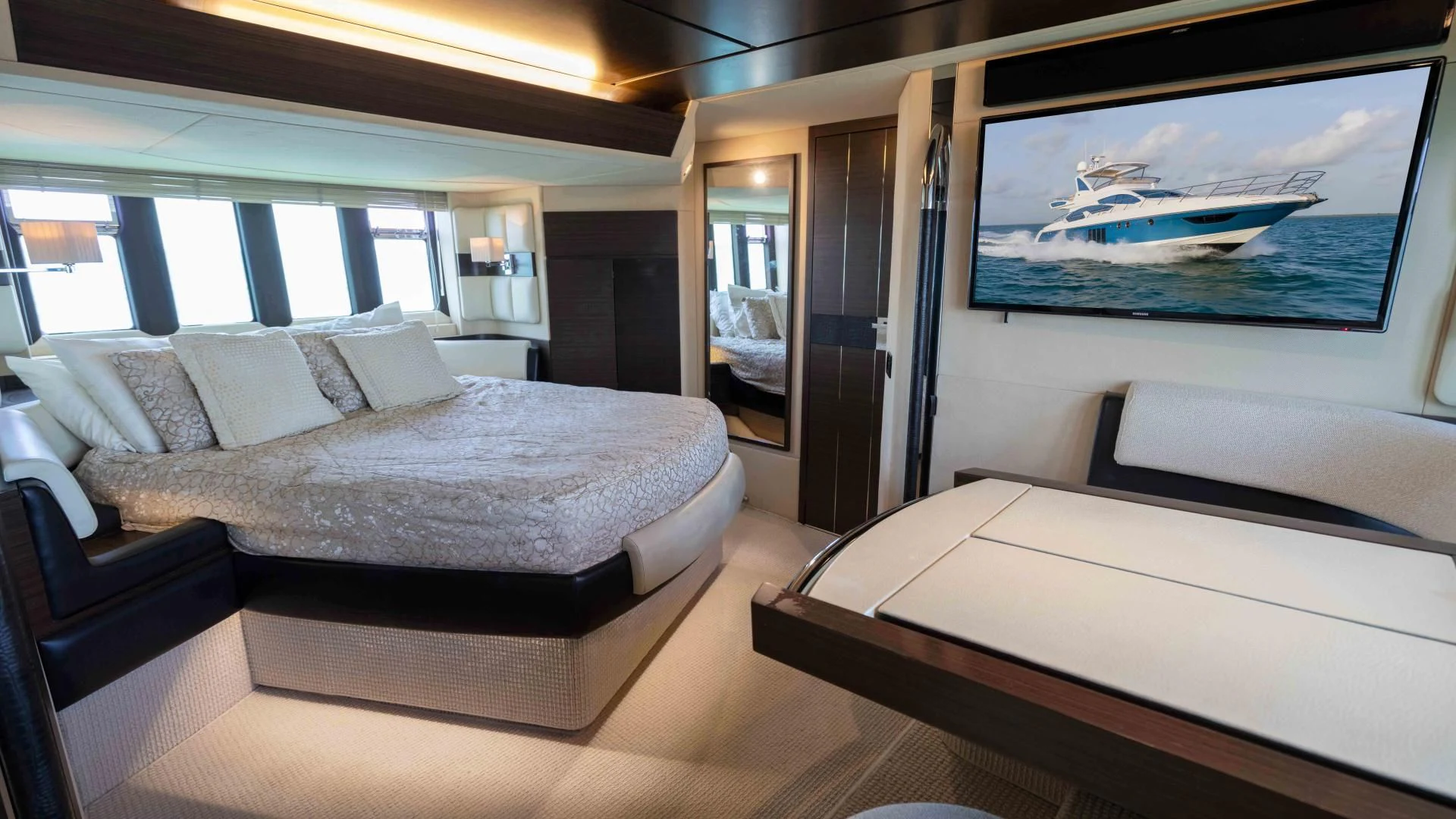 a room with a bed and a tv on the wall aboard 4-PLAY Yacht for Sale