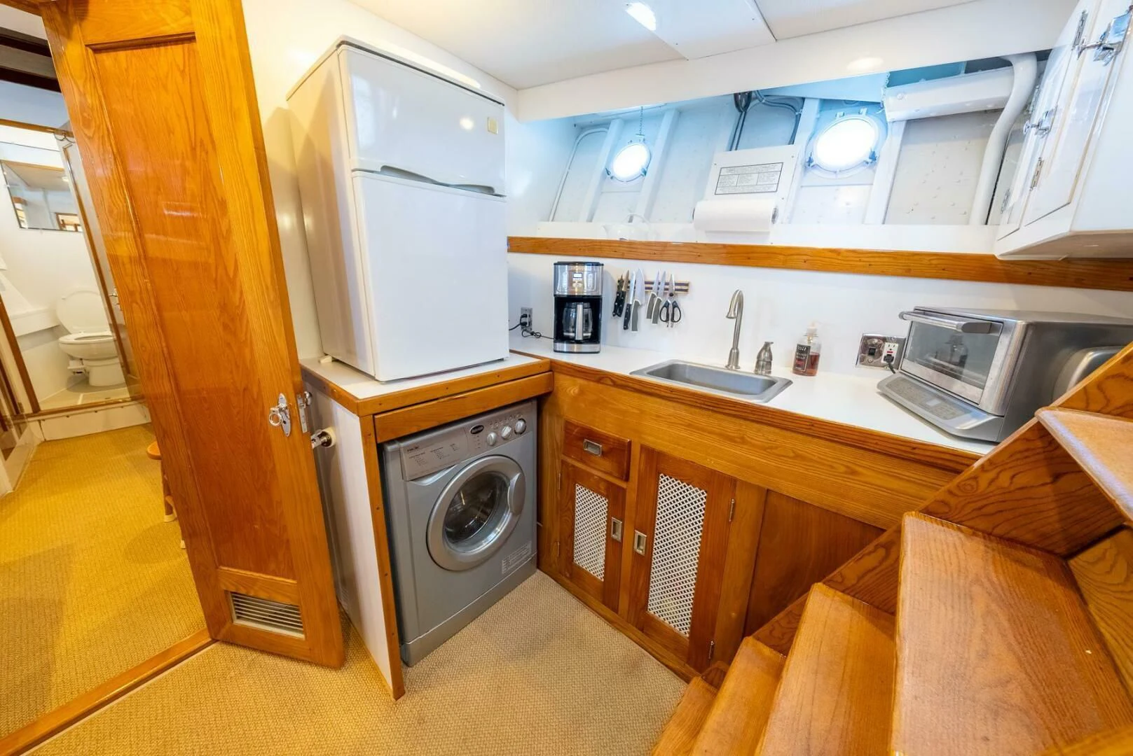 a kitchen with a microwave oven and cabinets aboard BERNADETTE Yacht for Sale