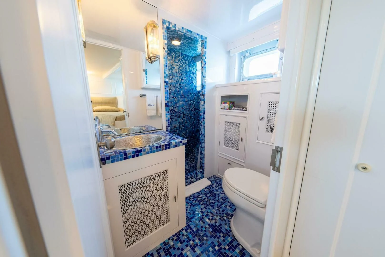 a bathroom with a blue floor aboard BERNADETTE Yacht for Sale