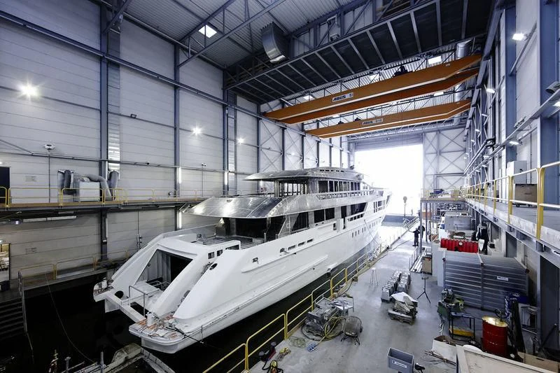 a large white boat in a warehouse aboard AZAMANTA Yacht for Sale