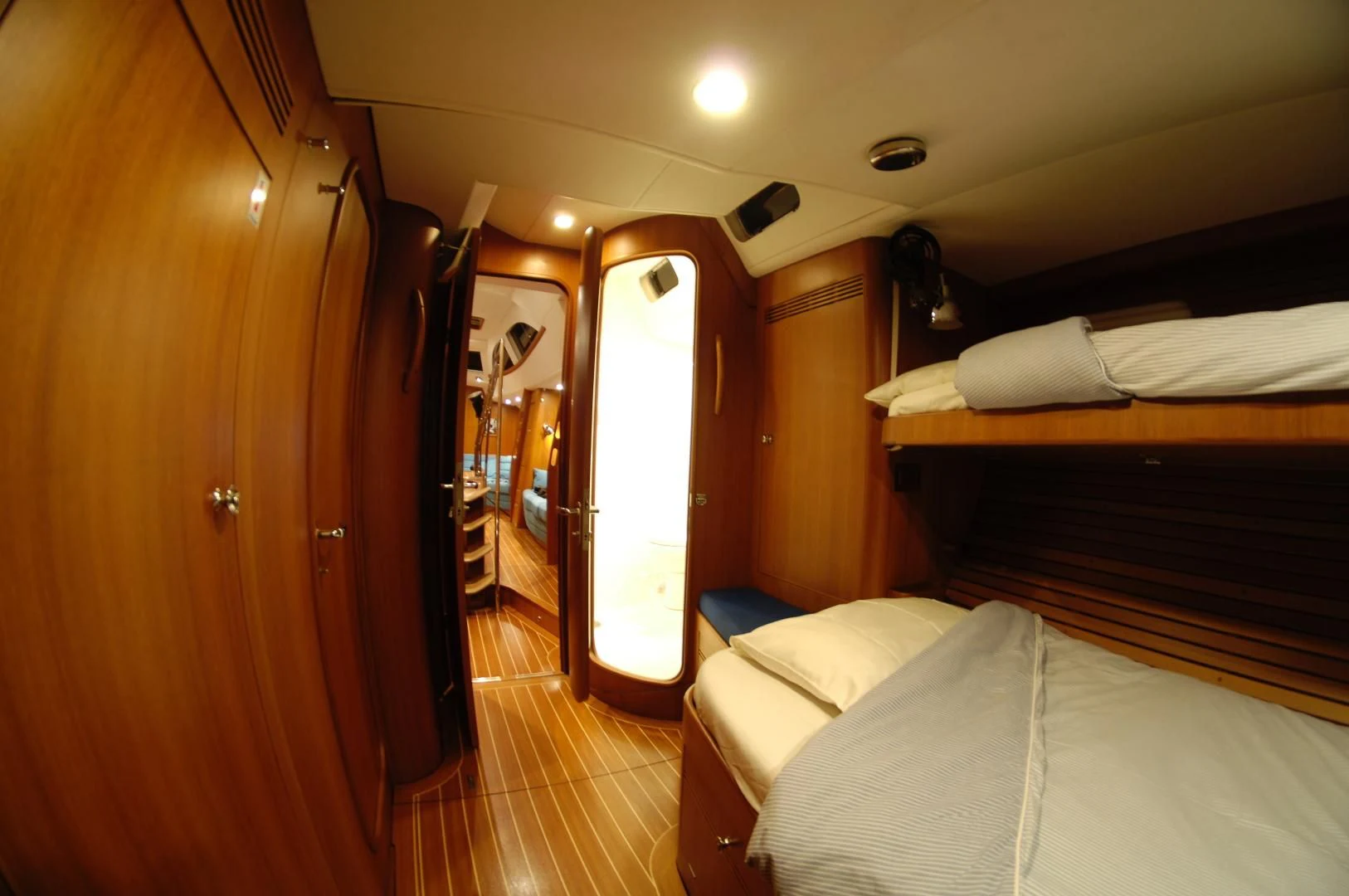 a room with a bed and a door aboard PULSAR II Yacht for Sale