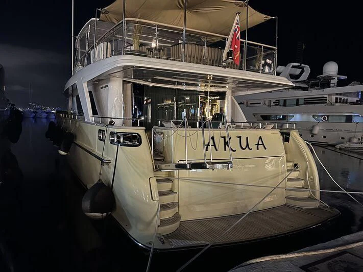 a boat docked at night aboard AKUA Yacht for Sale