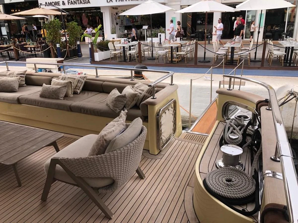 a lounge area with a couch and a coffee table aboard AKUA Yacht for Sale