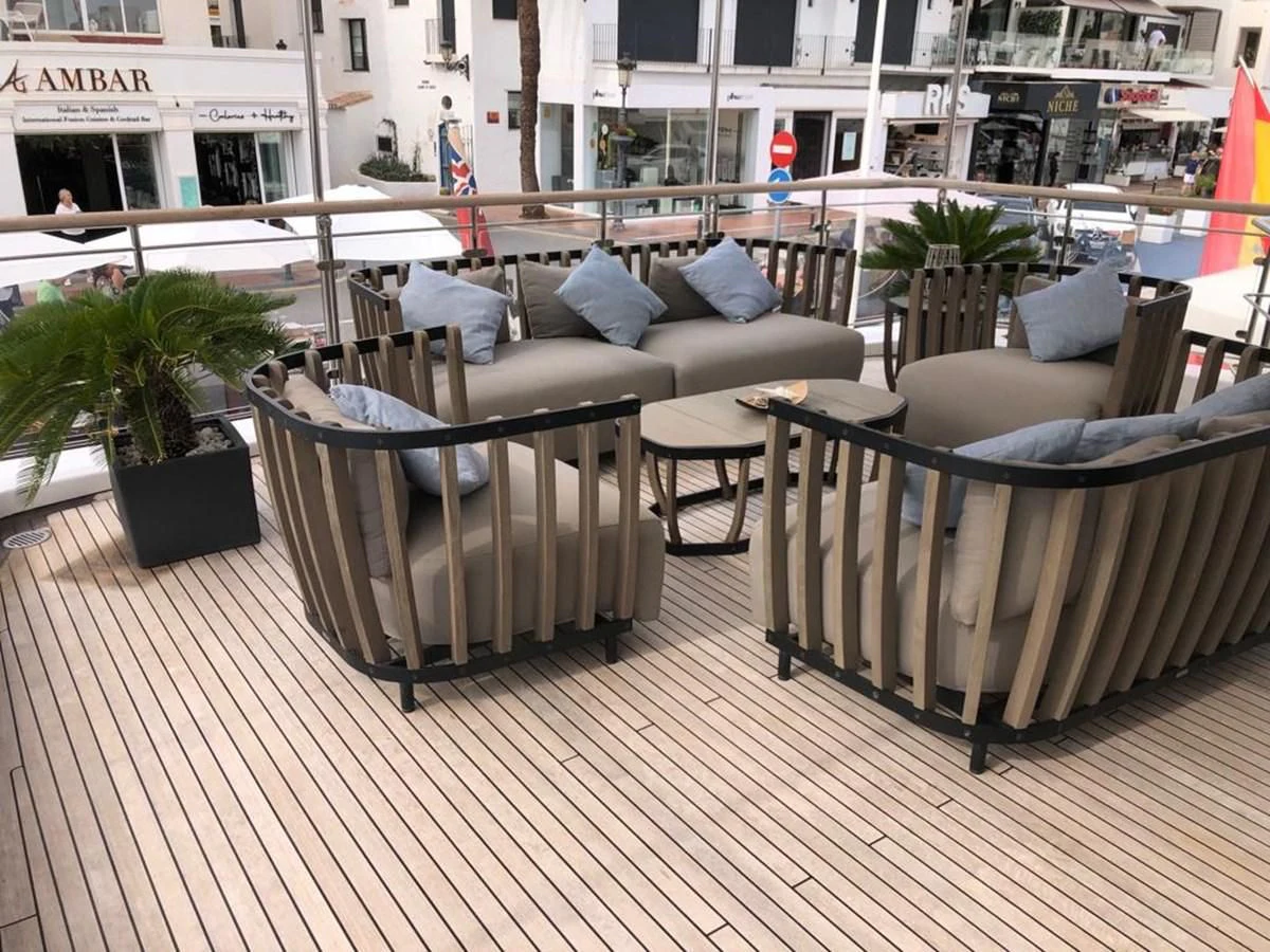 a couch and a table on a deck aboard AKUA Yacht for Sale