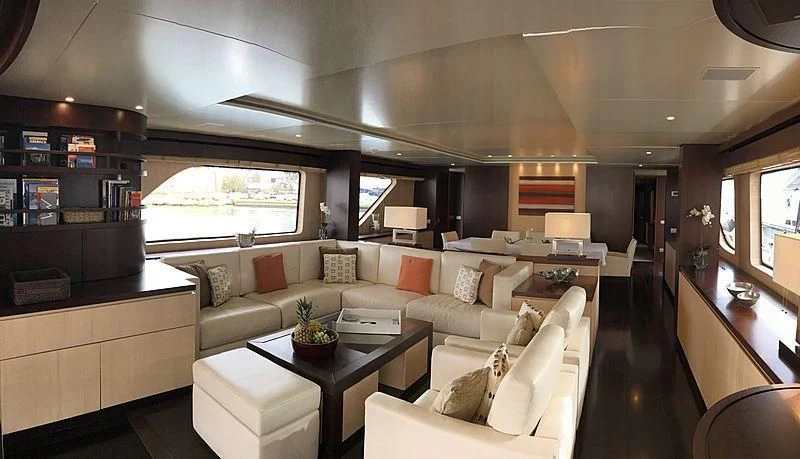 a living room with a couch and a coffee table aboard AKUA Yacht for Sale